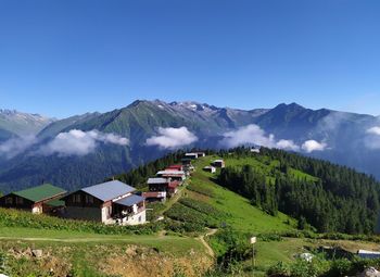 Houses on mountain against clear sky