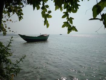 Boat in calm sea against sky