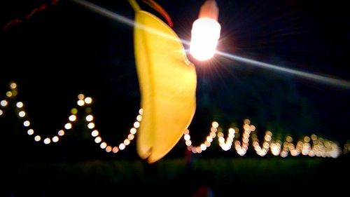 Low angle view of lit light bulb