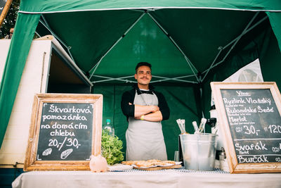 Portrait of smiling man standing in restaurant