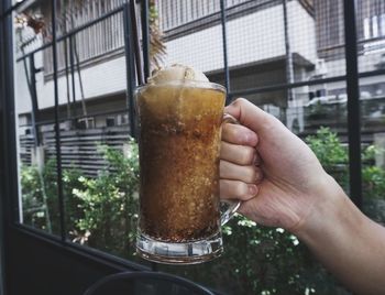 Close-up of hand holding drink