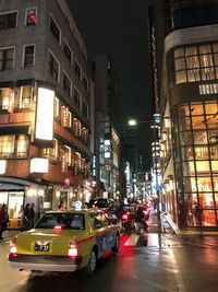 Traffic on city street and buildings at night