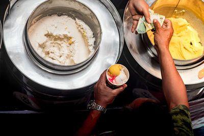 High angle view of a vendor selling thai coconut ice cream 