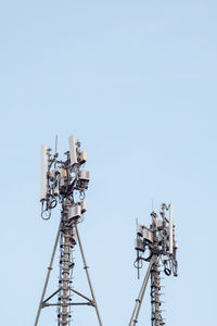 Low angle view of communications tower against sky