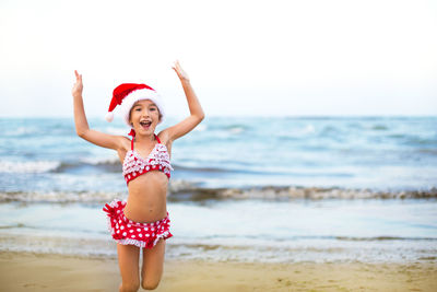 Full length of girl standing on beach