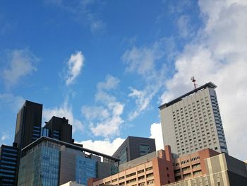 Low angle view of buildings against blue sky