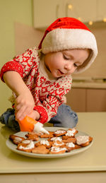 Happy boy in santa helper hats making cookies. kid cooking cookies