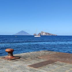 Scenic view of sea against clear blue sky