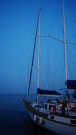 Boats sailing in sea against clear blue sky