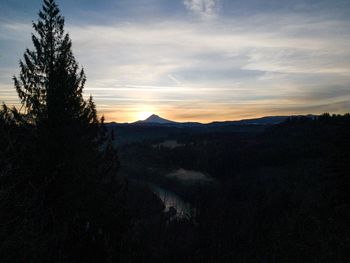 Scenic view of silhouette mountains against sky during sunset