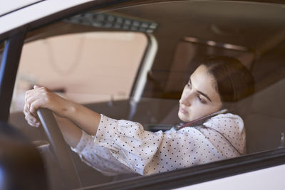 Portrait of woman sitting in car