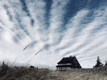 Houses on field against sky