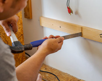 Midsection of man working on wood