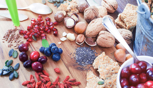 Close-up of fruits and seeds with nuts on wooden table