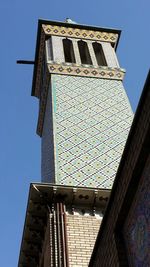 Low angle view of building against clear blue sky