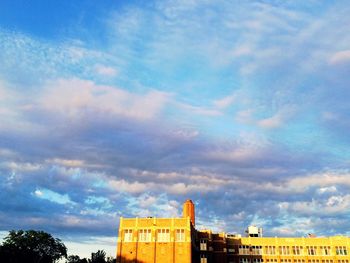 Low angle view of built structure against cloudy sky