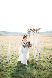 Portrait of woman with horse on field against clear sky