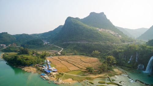 High angle view of river and mountains against clear sky