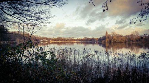 Scenic view of lake against cloudy sky