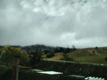 Raindrops on glass window of rainy season