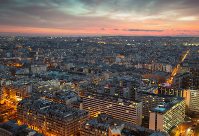 Aerial view of buildings against sky during sunset