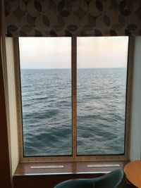 Scenic view of sea seen through window