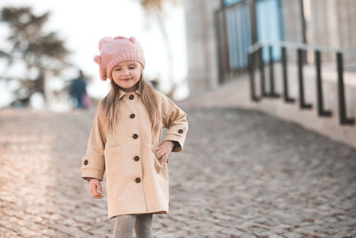 Cute girl walking on footpath