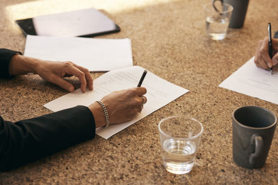 Cropped hands of man working at table