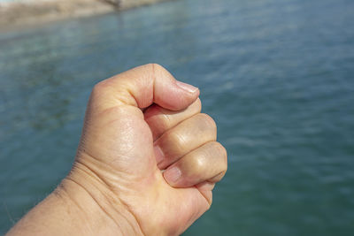 Close-up of person hand holding water