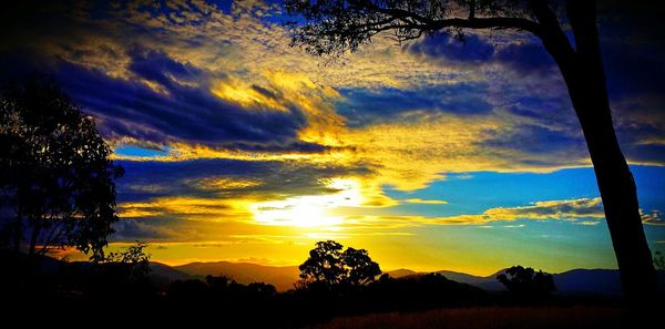 Silhouette of landscape against cloudy sky