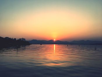 Scenic view of sea against orange sky