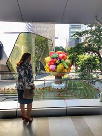 Woman standing against glass wall