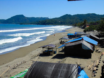 Scenic view of beach against blue sky