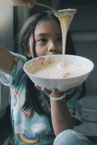 Portrait of girl holding ice cream