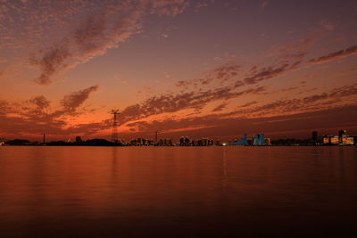 Scenic view of sea against orange sky