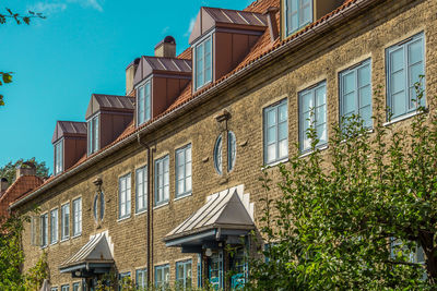 Low angle view of building by street against sky