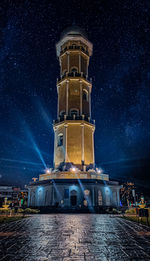 Low angle view of illuminated building against sky at night