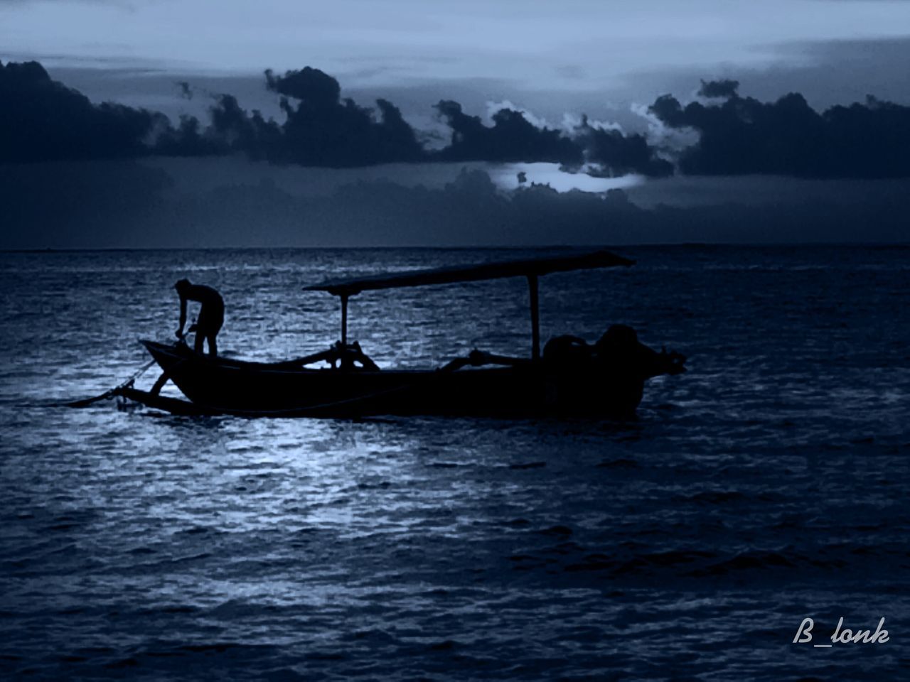 water, transportation, nautical vessel, sea, mode of transport, boat, sky, tranquility, scenics, tranquil scene, beauty in nature, waterfront, horizon over water, silhouette, nature, rippled, men, idyllic, travel