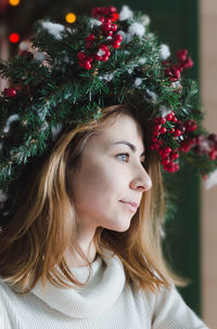 Young woman with christmas tree at home