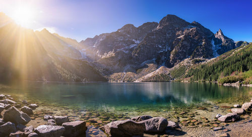 Scenic view of lake and mountains against sky