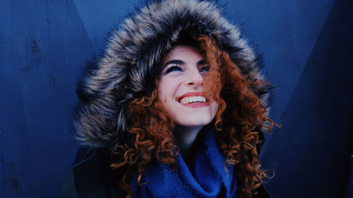 Smiling young woman wearing fur coat