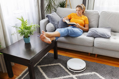 Portrait of woman sitting on sofa at home