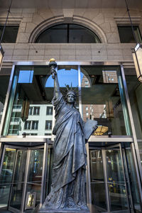 Low angle view of statue against building