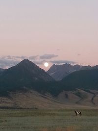 Scenic view of mountains against sky at sunset