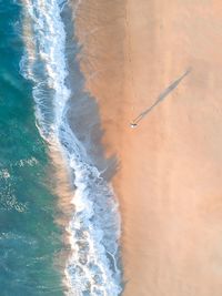 Aerial view of man walking at beach