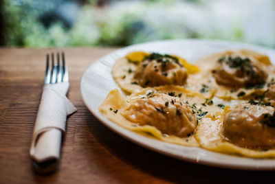 Close-up of cooked pasta with fork at table