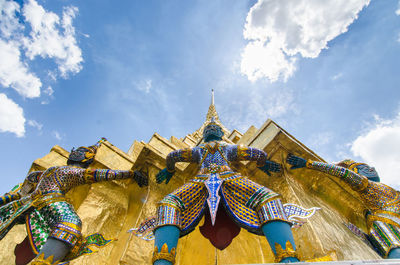 Low angle view of temple against cloudy sky