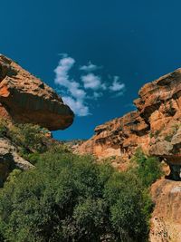 Low angle view of rock formations against sky
