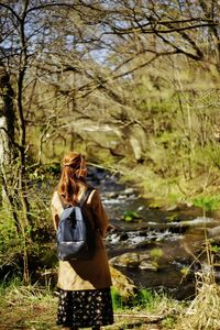 Rear view of woman with dog on field