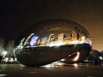 Close-up of illuminated buildings against sky at night